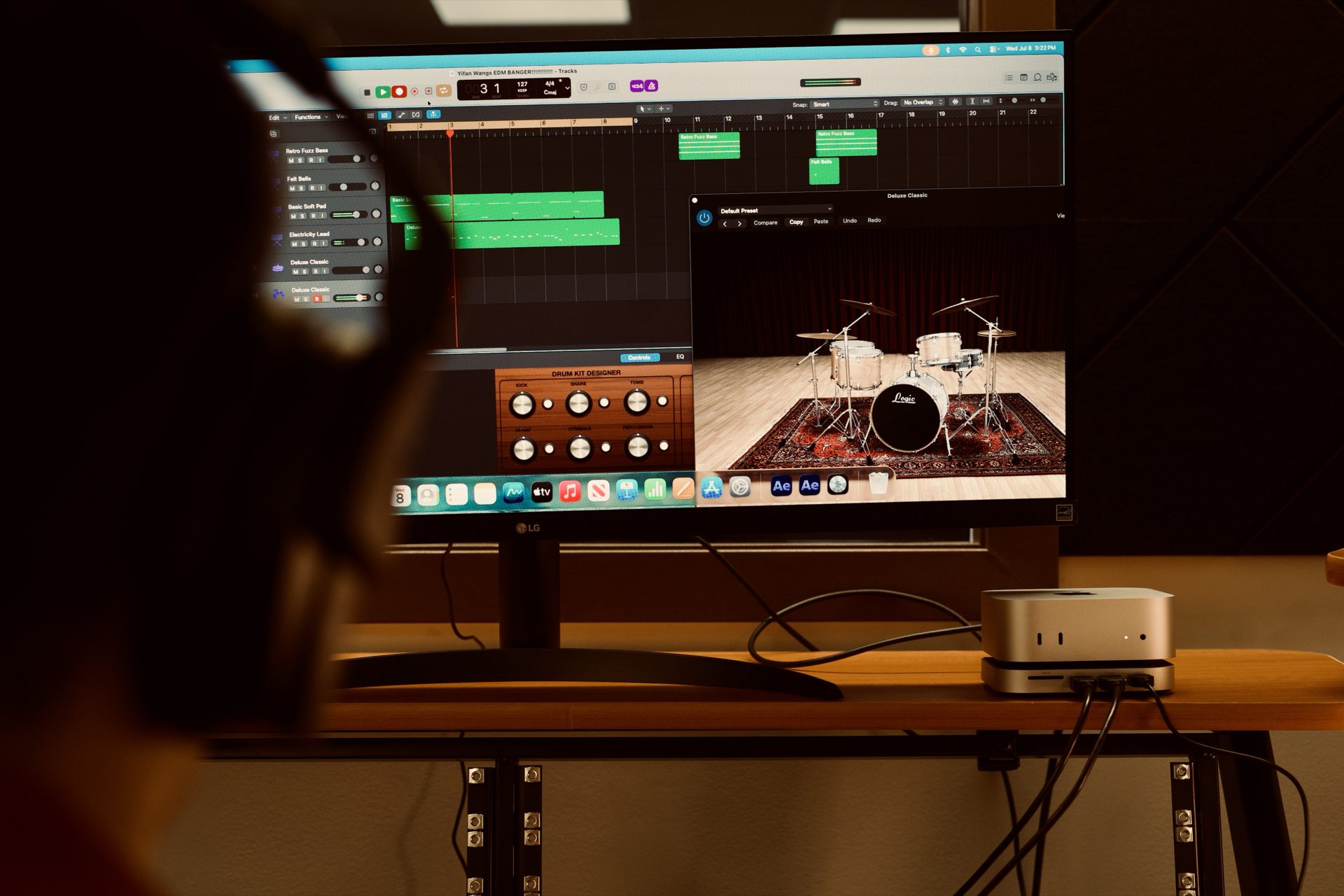 Producer's desk with a DAW session, studio monitors, and headphones