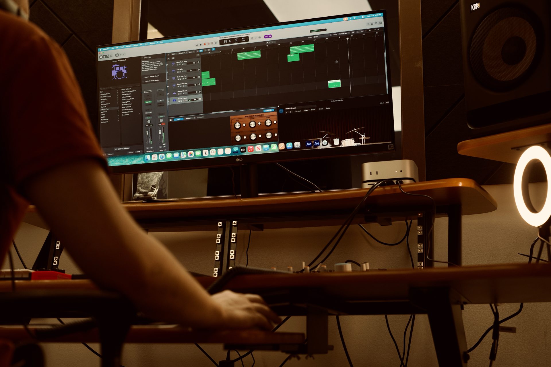 Producer working at the music production desk with studio monitors and mixing gear