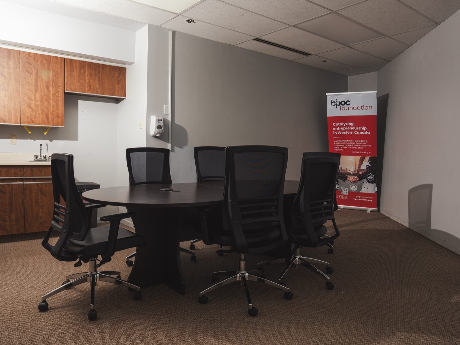 Conference room with a meeting table, seating, and presentation space