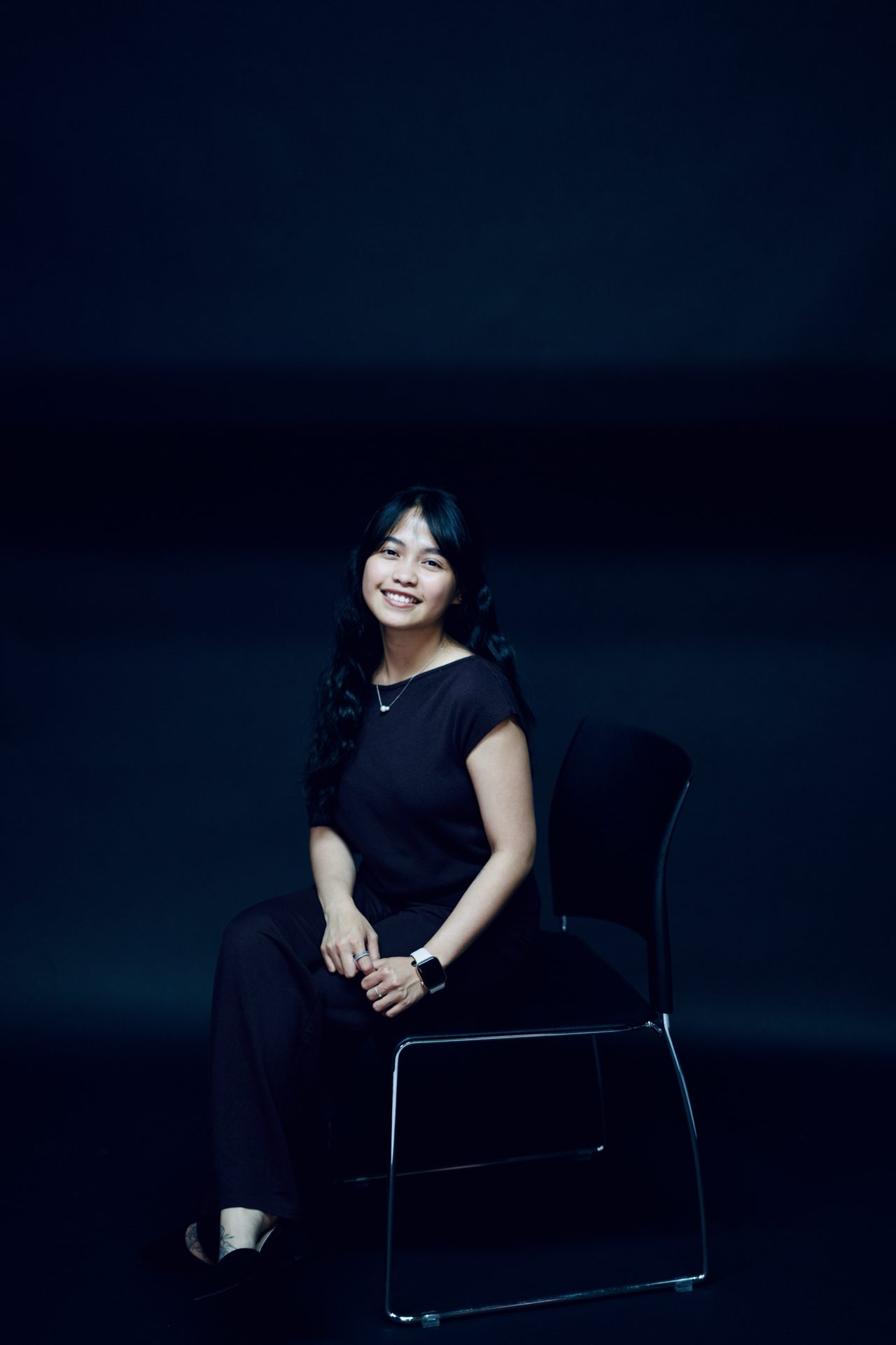 Studio portrait session against a black backdrop